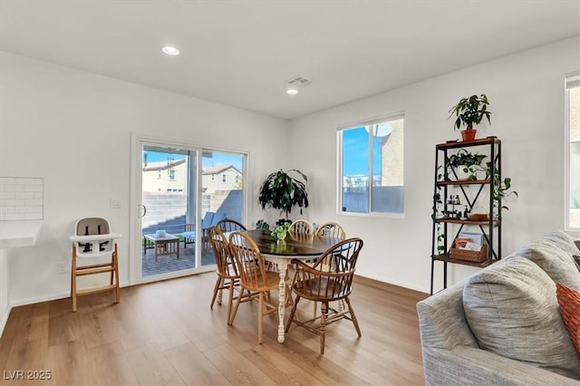 dining area with recessed lighting, wood finished floors, and visible vents