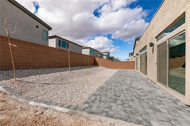 view of yard featuring a patio and a fenced backyard