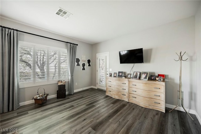 bedroom with visible vents, baseboards, and dark wood-style floors