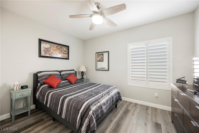 bedroom featuring ceiling fan, baseboards, and wood finished floors