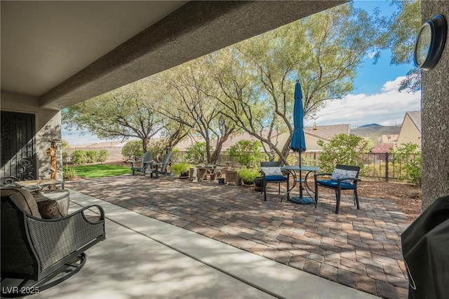 view of patio / terrace with a grill, a fenced backyard, and outdoor dining space