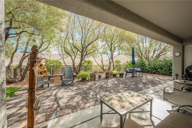 view of patio / terrace featuring grilling area, outdoor dining space, and a fenced backyard