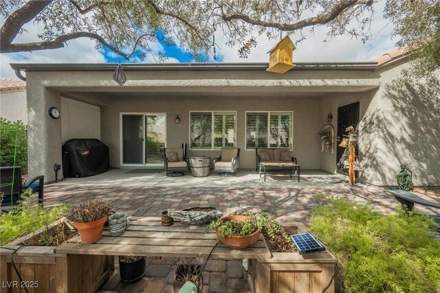 back of house with a patio area and stucco siding