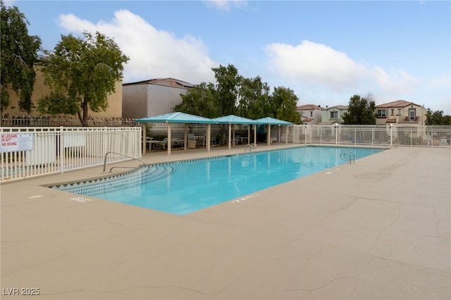 pool featuring a patio area and fence