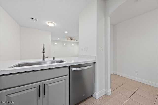 kitchen with light tile patterned floors, a ceiling fan, baseboards, a sink, and dishwasher