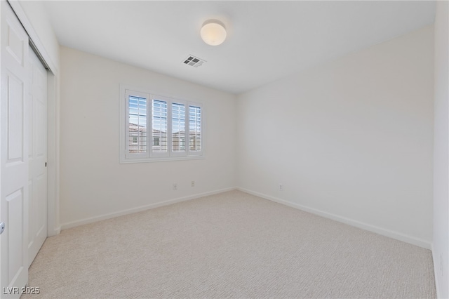 unfurnished bedroom with visible vents, baseboards, carpet, and a closet