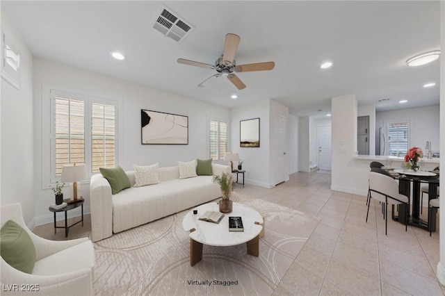 living area featuring recessed lighting, visible vents, a wealth of natural light, and ceiling fan