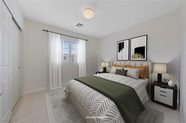 bedroom with visible vents, baseboards, light colored carpet, and a closet