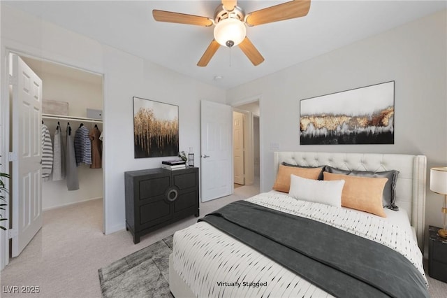 bedroom featuring a ceiling fan, carpet, and a spacious closet