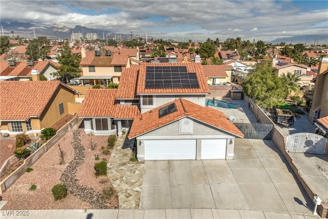 view of front of house with fence, a residential view, a tiled roof, stucco siding, and a gate