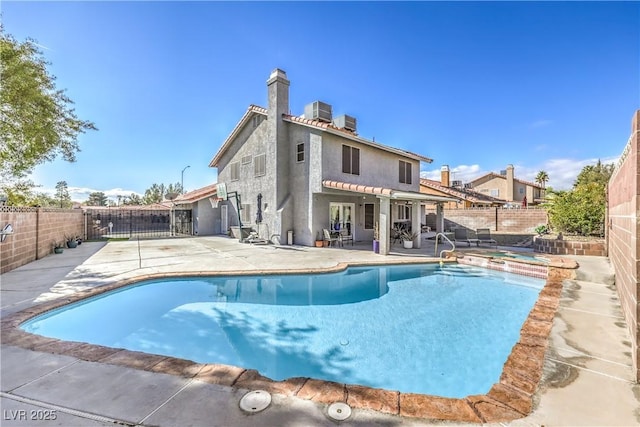 view of swimming pool featuring a fenced in pool, a fenced backyard, and a patio area