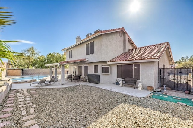 back of house featuring a fenced backyard, a pergola, stucco siding, a tiled roof, and a patio area