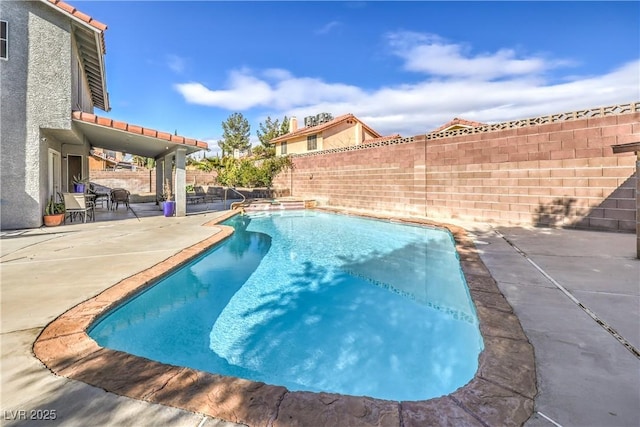 view of swimming pool with a fenced in pool, a fenced backyard, and a patio area