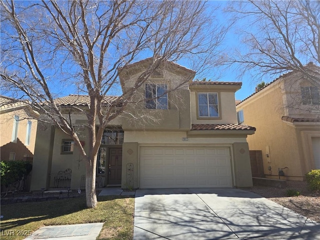 mediterranean / spanish home with stucco siding, a garage, driveway, and a tiled roof