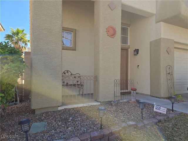 view of exterior entry with stucco siding