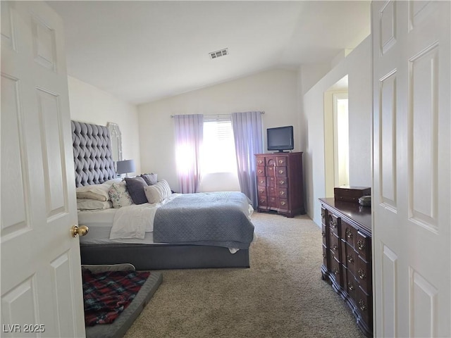 carpeted bedroom featuring visible vents and lofted ceiling