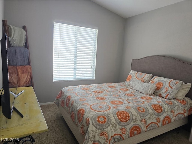 bedroom with baseboards and carpet