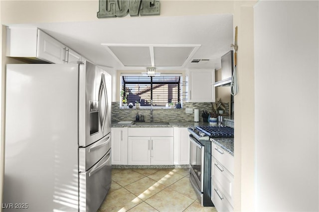 3258 Del Marino St, Las Vegas, NV 89121 - kitchen featuring stainless steel appliances, white cabinetry, decorative backsplash, light tile patterned floors, and stone counters