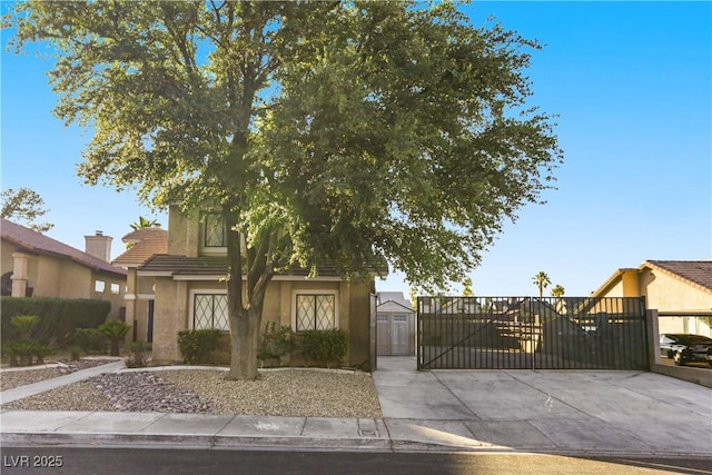 3258 Del Marino St, Las Vegas, NV 89121 - obstructed view of property featuring stucco siding, a gate, a tile roof, and a storage shed