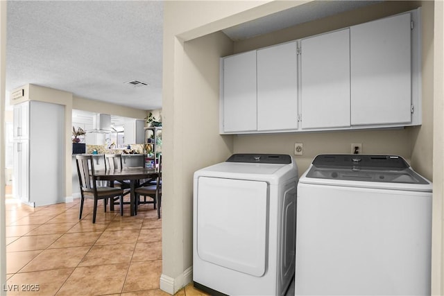 3258 Del Marino St, Las Vegas, NV 89121 - laundry area featuring washer and dryer, cabinet space, light tile patterned flooring, and a textured ceiling