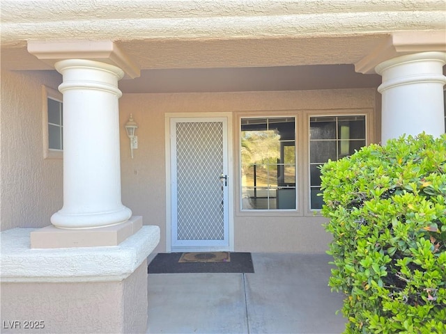 entrance to property with stucco siding