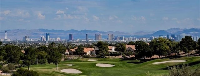 view of community with a city view, view of golf course, and a mountain view