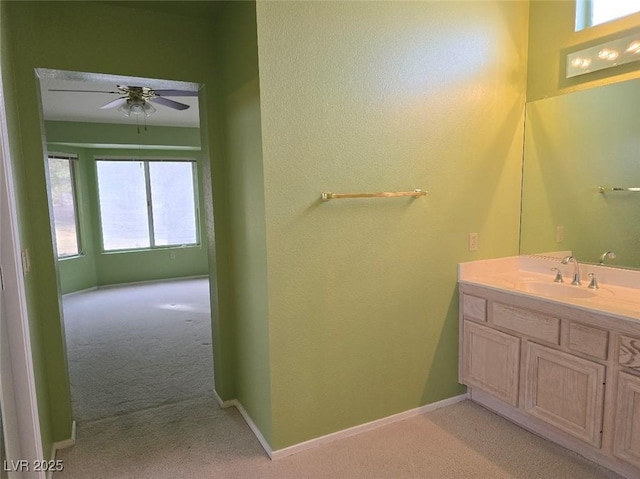 bathroom with vanity, baseboards, and a ceiling fan