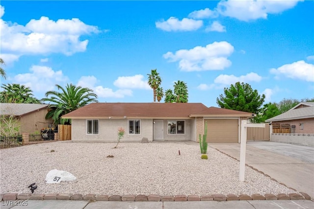 ranch-style home with stucco siding, driveway, a garage, and fence