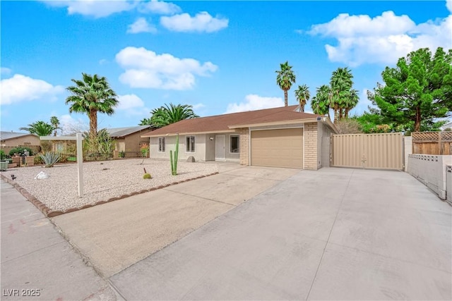 ranch-style home with driveway, a gate, fence, a garage, and brick siding