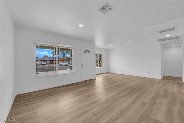 unfurnished living room with recessed lighting, visible vents, baseboards, and light wood-style flooring