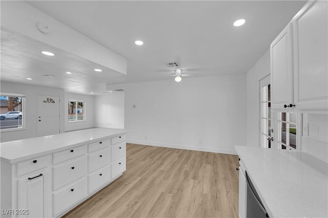 kitchen featuring light wood-style flooring, a ceiling fan, recessed lighting, light countertops, and baseboards