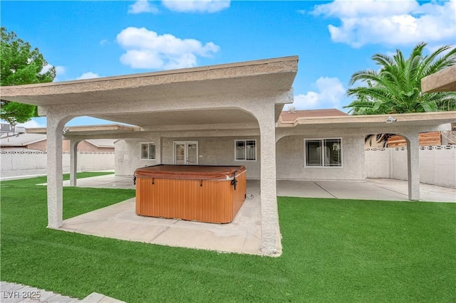 view of patio / terrace with fence and a hot tub