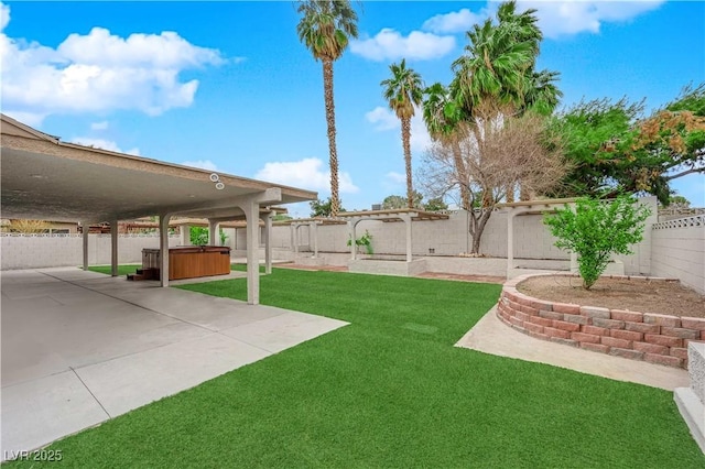 view of yard with a patio, a fenced backyard, and a hot tub