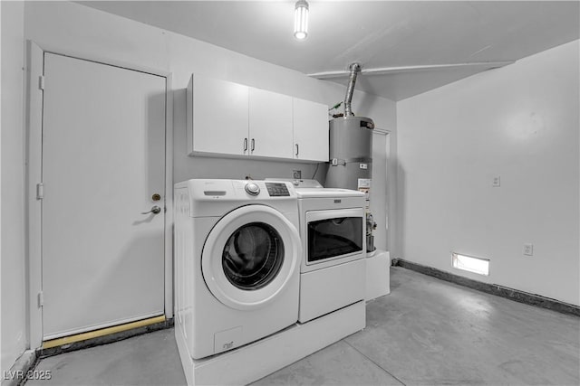 laundry area with baseboards, cabinet space, water heater, and washer and clothes dryer