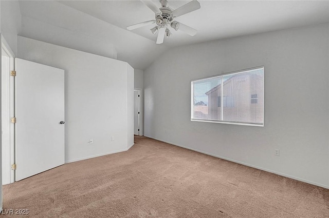 unfurnished bedroom featuring baseboards, ceiling fan, carpet flooring, and vaulted ceiling