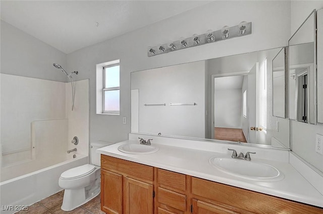 bathroom with tile patterned flooring, toilet, shower / bathing tub combination, and a sink