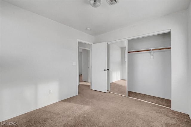 unfurnished bedroom featuring baseboards, visible vents, carpet floors, and a closet