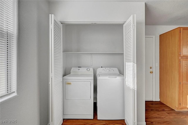 laundry room with laundry area, a textured ceiling, wood finished floors, and separate washer and dryer