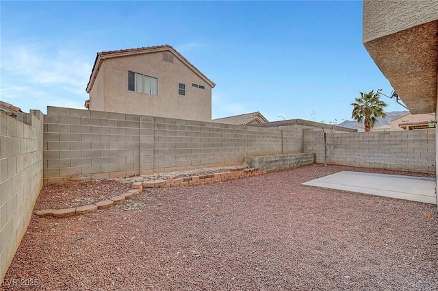 view of yard with a fenced backyard and a patio area