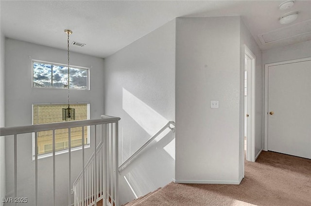 stairs featuring visible vents, baseboards, and carpet floors