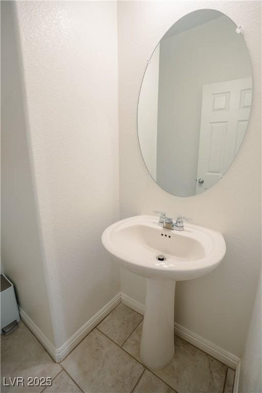 bathroom featuring tile patterned flooring and baseboards