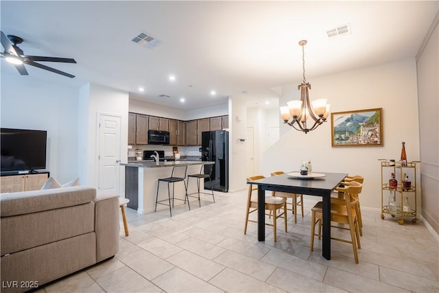 dining room with light tile patterned floors, visible vents, recessed lighting, and ceiling fan with notable chandelier