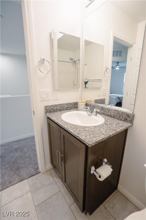 bathroom with tile patterned floors, visible vents, vanity, and baseboards