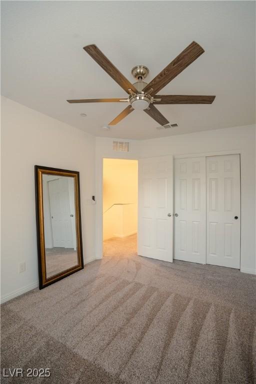 unfurnished bedroom with a closet, visible vents, baseboards, and carpet