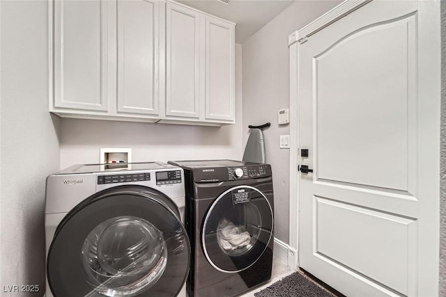 clothes washing area featuring cabinet space and separate washer and dryer