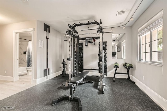 exercise room featuring baseboards and visible vents