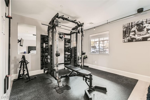 exercise room featuring baseboards