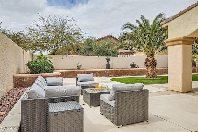 view of patio / terrace featuring an outdoor living space with a fire pit and a fenced backyard