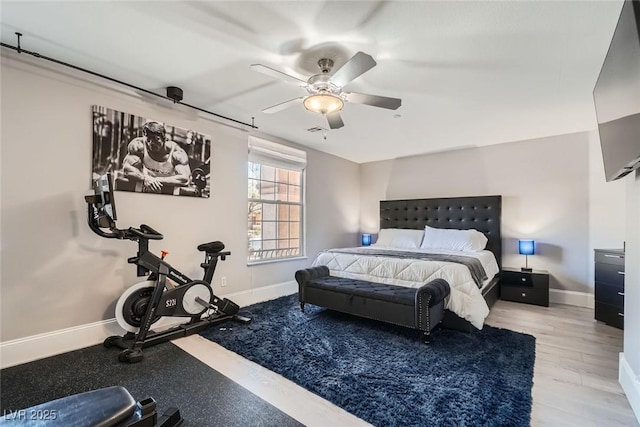 bedroom featuring visible vents, a ceiling fan, and baseboards