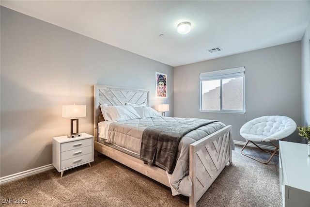 bedroom with baseboards, visible vents, and dark carpet